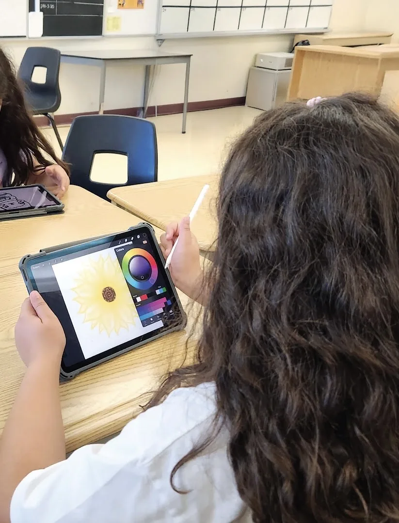 Student using an iPad and Apple Pencil in a Pen & Tablet digital art class