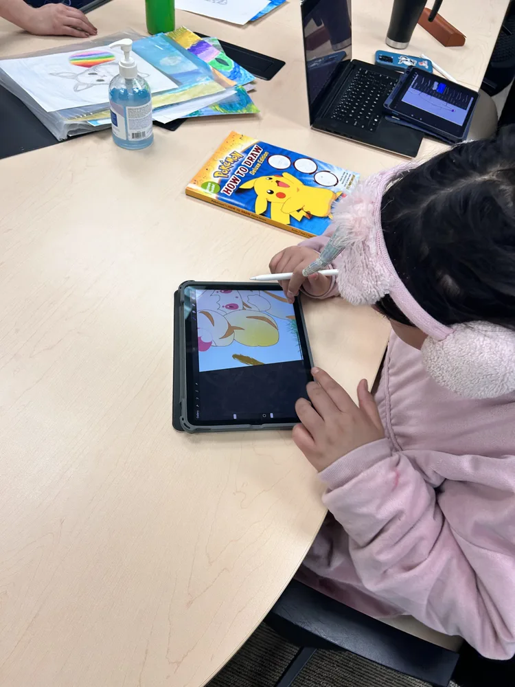 Student working on digital art using an iPad in class